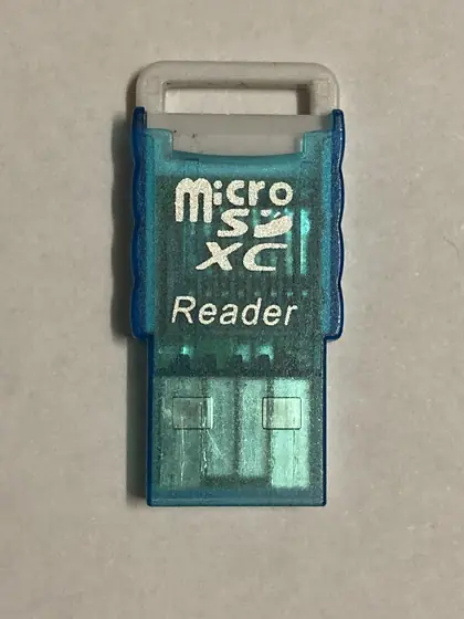A small USB stick that holds a microSD card.
