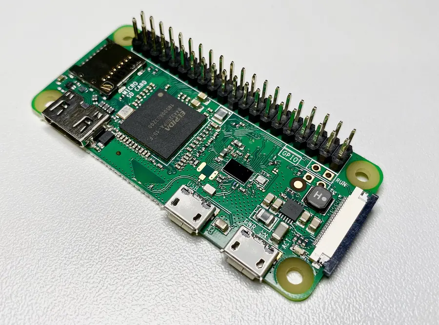 A Raspberry Pi Zero WH board with a row of 40 metal pins sticking up along one edge.