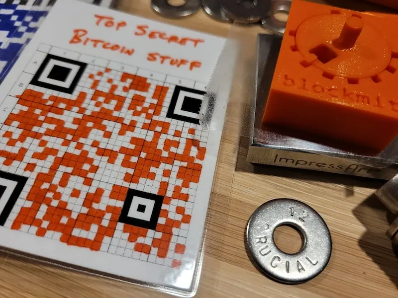 A QR code copied by hand onto a paper grid card.